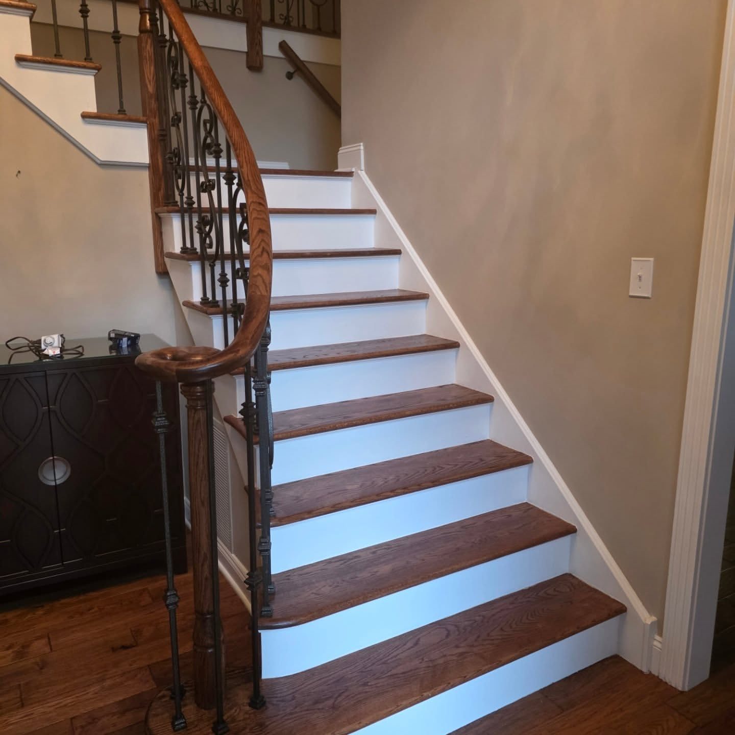 Modern staircase with oak treads and black metal railing